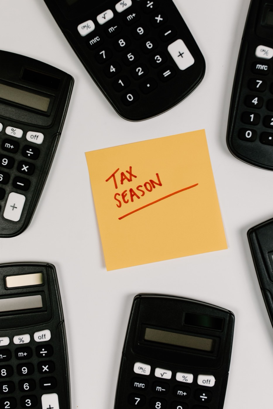 Sticky note that reads TAX SEASON next to a calculator